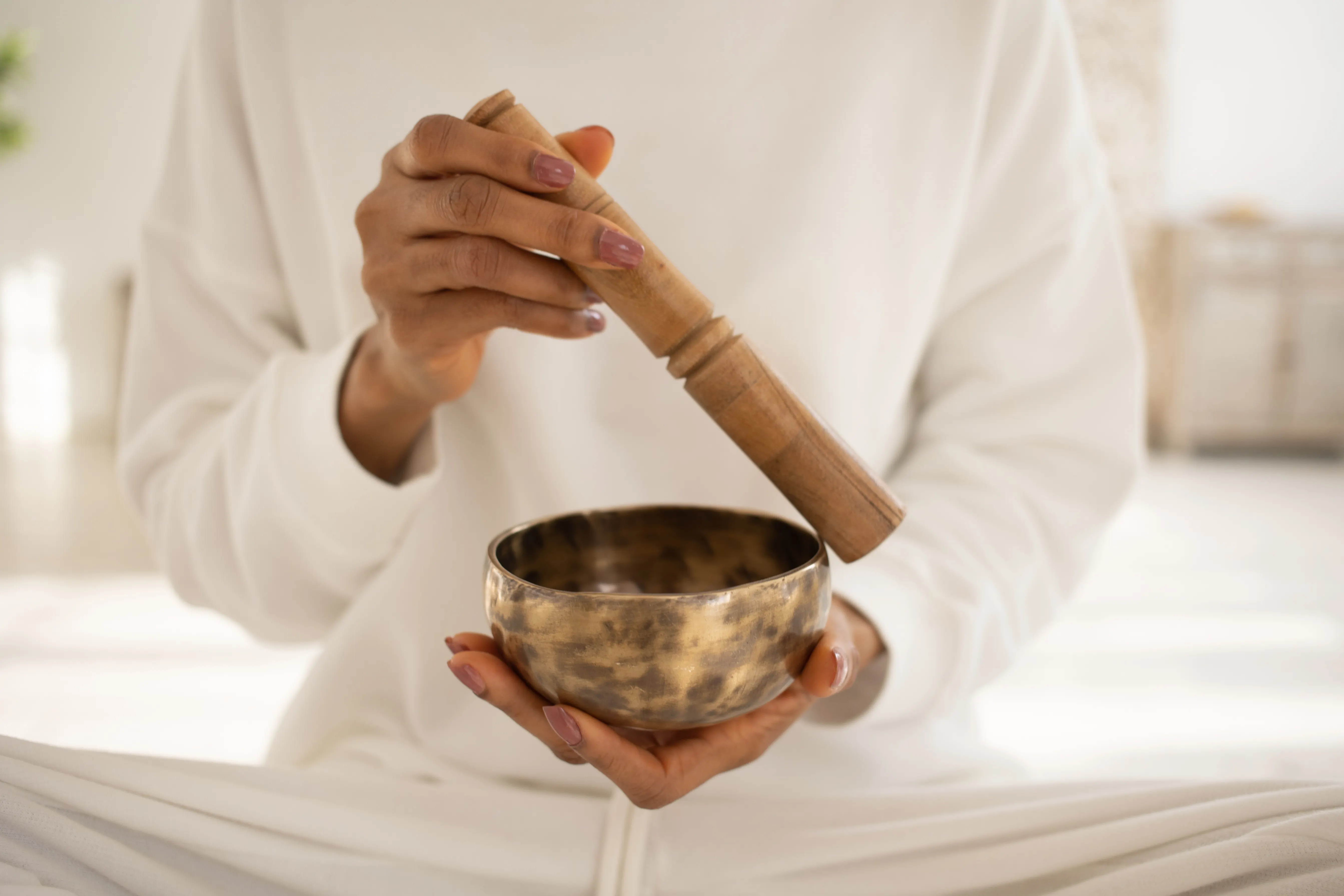 Close-up of a person playing a Tibetan singing bowl